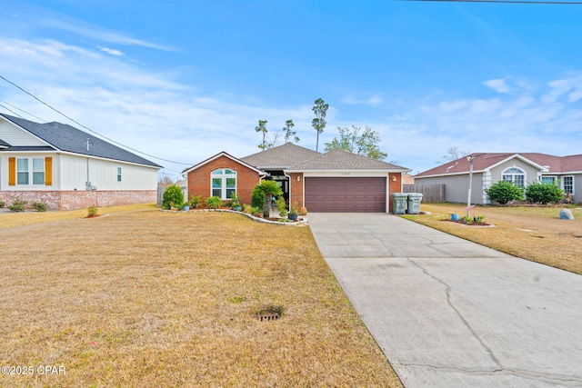 view of front of home with a garage, a front yard, concrete driveway, and brick siding