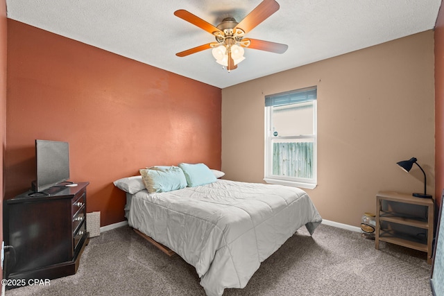 bedroom with ceiling fan, a textured ceiling, baseboards, and carpet flooring