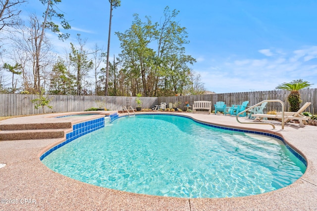 view of swimming pool with a fenced backyard, a patio, a fenced in pool, and an in ground hot tub