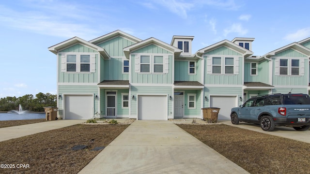 view of front of house featuring board and batten siding, roof with shingles, driveway, and a garage