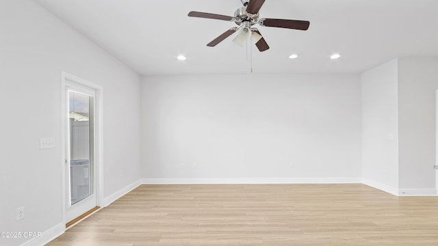 empty room with recessed lighting, light wood-type flooring, and baseboards