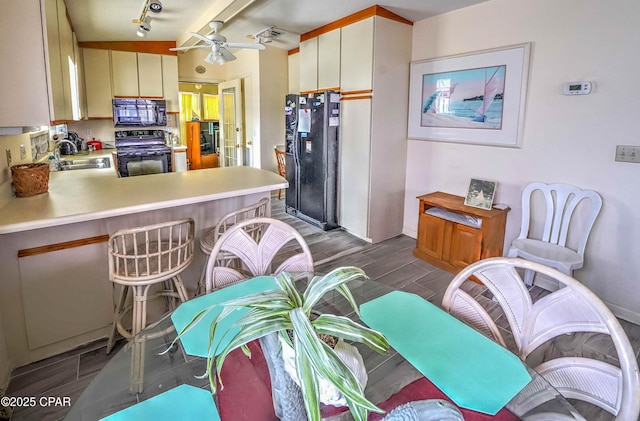 423 Snook Ln, Panama City Beach, FL 32408 - kitchen featuring black appliances, sink, ceiling fan, kitchen peninsula, and track lighting