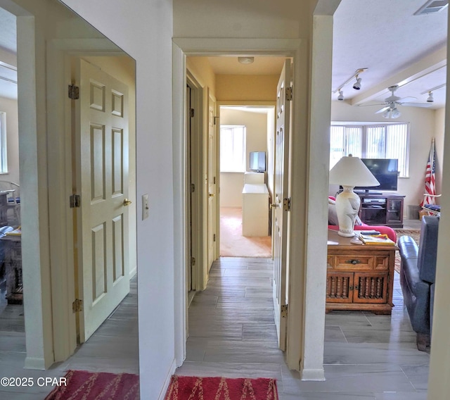 423 Snook Ln, Panama City Beach, FL 32408 - corridor with track lighting and light hardwood / wood-style floors