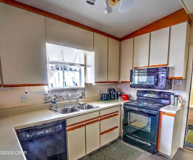 423 Snook Ln, Panama City Beach, FL 32408 - kitchen featuring sink, black appliances, white cabinets, and ceiling fan