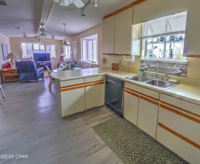 423 Snook Ln, Panama City Beach, FL 32408 - kitchen featuring sink, kitchen peninsula, dishwasher, ceiling fan, and decorative backsplash