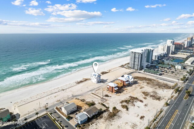 birds eye view of property with a water view and a view of the beach