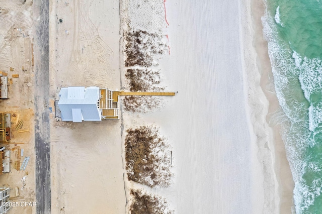 birds eye view of property featuring a water view and a beach view