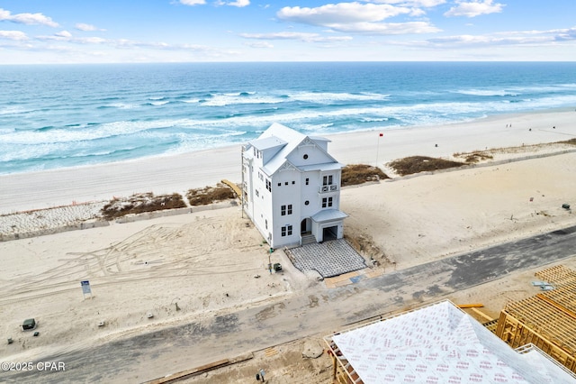 birds eye view of property with a beach view and a water view