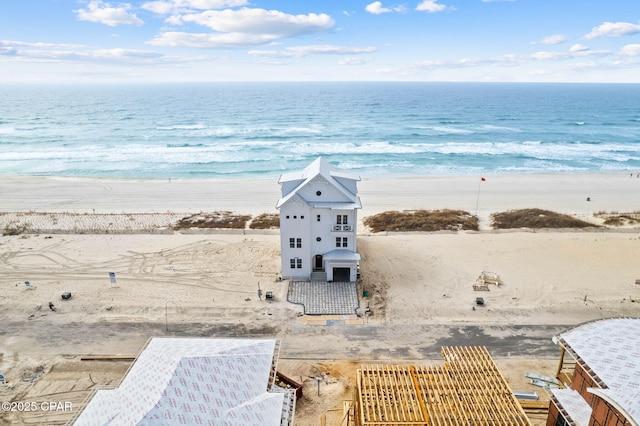 birds eye view of property with a view of the beach and a water view