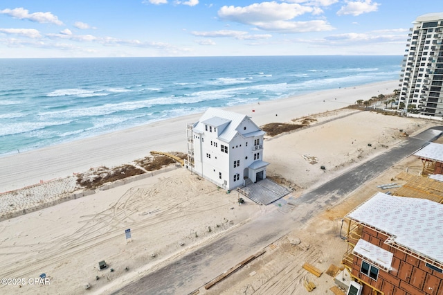 drone / aerial view featuring a water view and a view of the beach