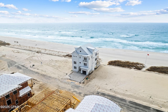 bird's eye view with a water view and a beach view