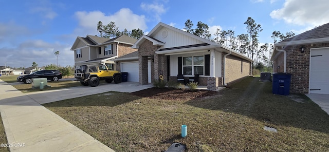 view of front of home with a garage, a front lawn, and covered porch