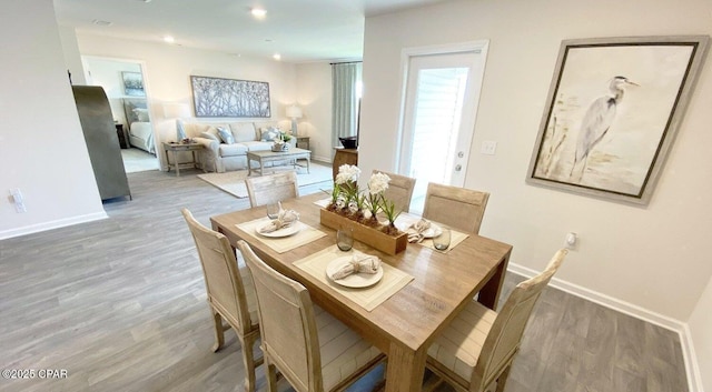 dining space with hardwood / wood-style flooring and plenty of natural light