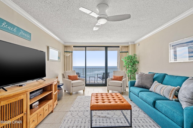 living room with crown molding, a water view, light tile patterned flooring, ceiling fan, and a textured ceiling