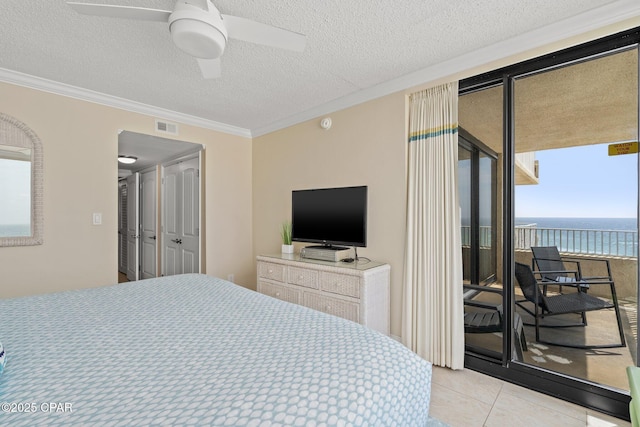 bedroom featuring a textured ceiling, ornamental molding, and visible vents