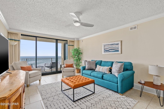 living area featuring ceiling fan, a textured ceiling, a water view, visible vents, and crown molding