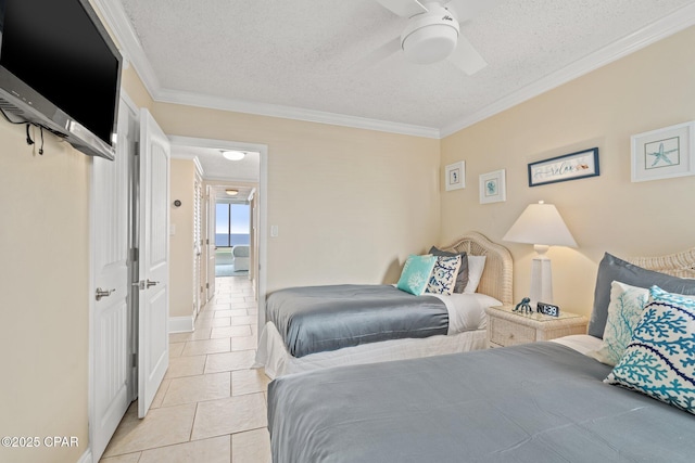 bedroom featuring crown molding, light tile patterned floors, a ceiling fan, a textured ceiling, and baseboards