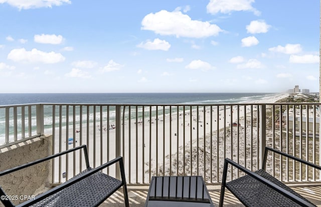 balcony with a water view and a beach view