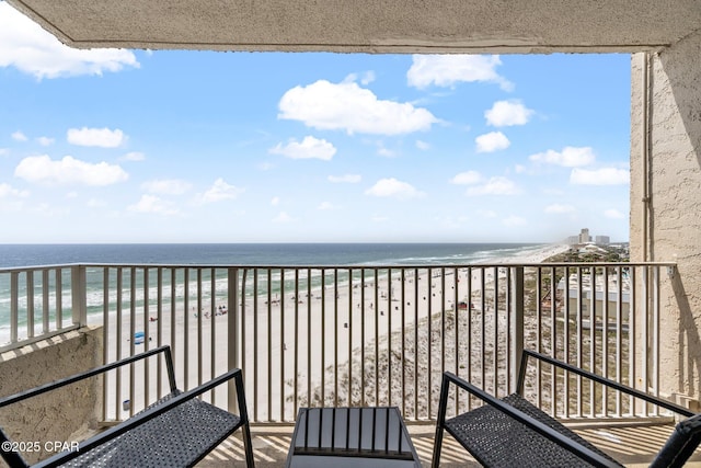 balcony with a water view and a beach view