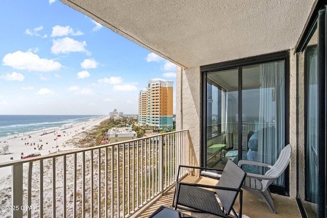 balcony with a beach view and a water view