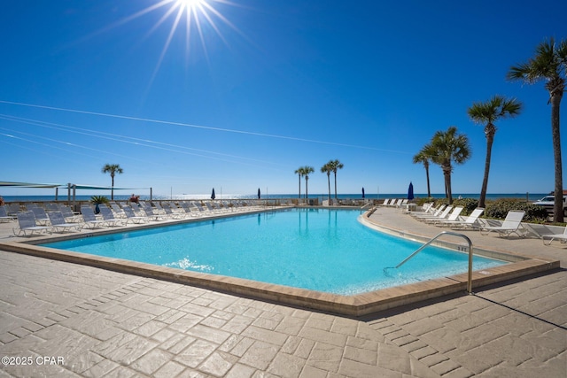 pool with a water view and a patio