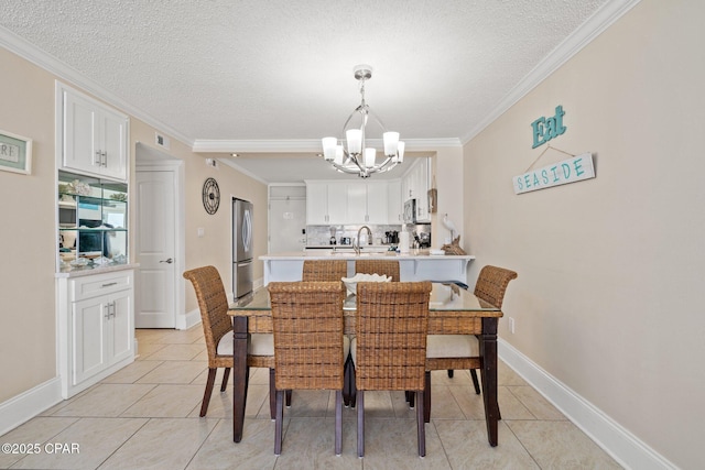 dining room with a chandelier, a textured ceiling, light tile patterned flooring, and crown molding