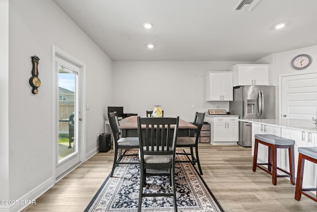 dining area featuring plenty of natural light and light hardwood / wood-style floors