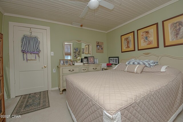 carpeted bedroom with ceiling fan and ornamental molding