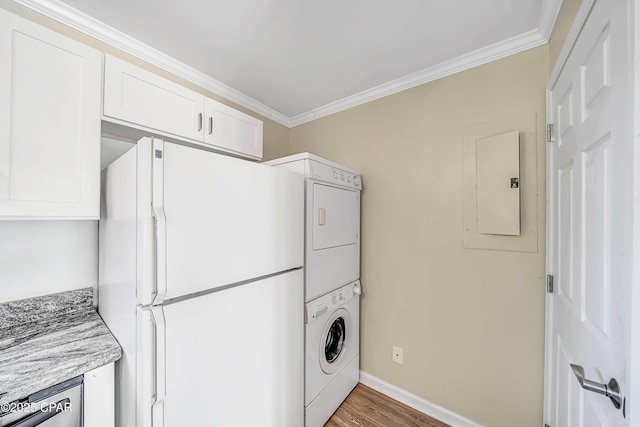 laundry area featuring hardwood / wood-style flooring, stacked washer and dryer, ornamental molding, and electric panel