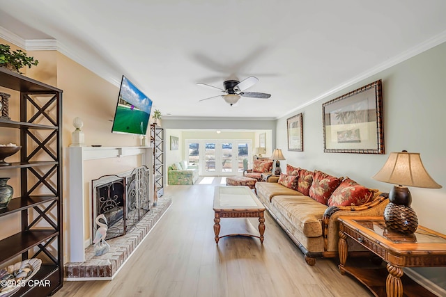 living room with crown molding, french doors, and light wood-type flooring