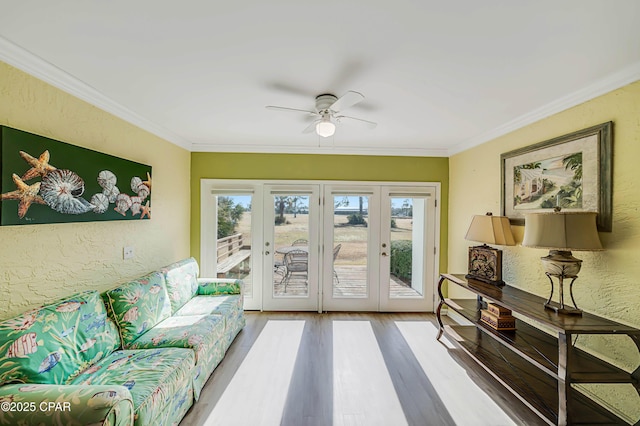 doorway to outside with crown molding, hardwood / wood-style floors, ceiling fan, and french doors