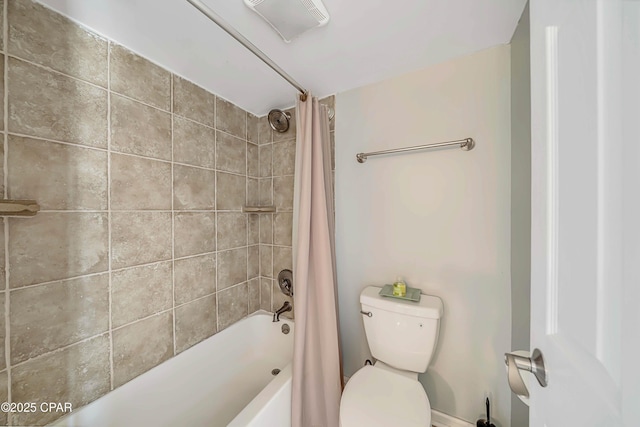 bathroom featuring shower / bath combination with curtain and toilet