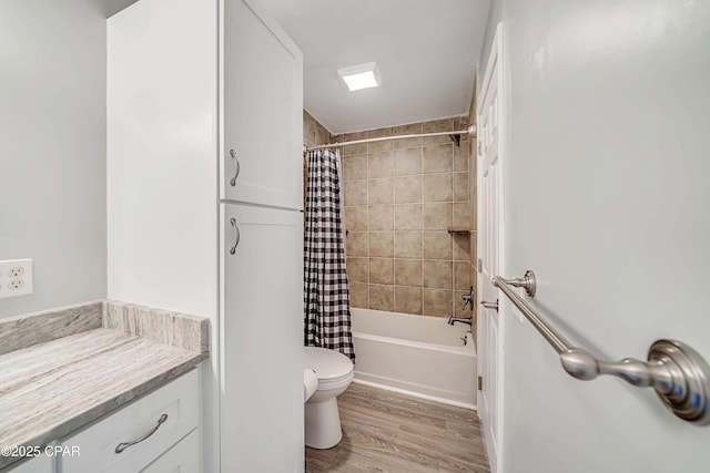 full bathroom featuring vanity, toilet, hardwood / wood-style floors, and shower / bath combo with shower curtain