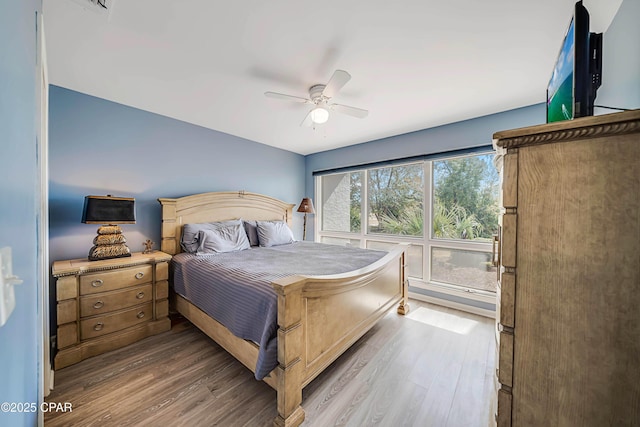 bedroom with hardwood / wood-style flooring and ceiling fan