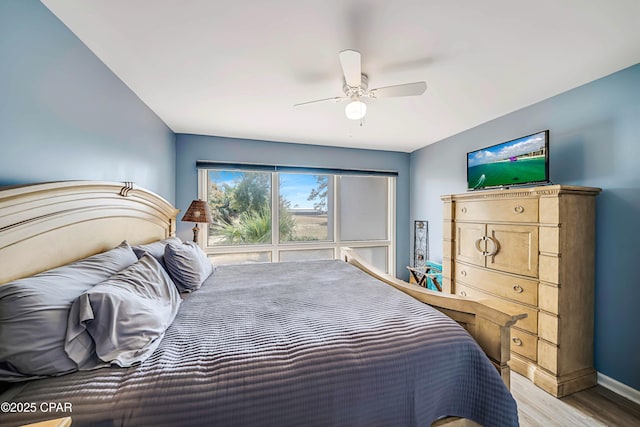 bedroom with light hardwood / wood-style floors and ceiling fan