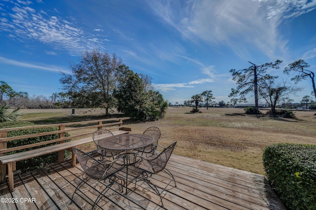 wooden deck with a yard and a rural view