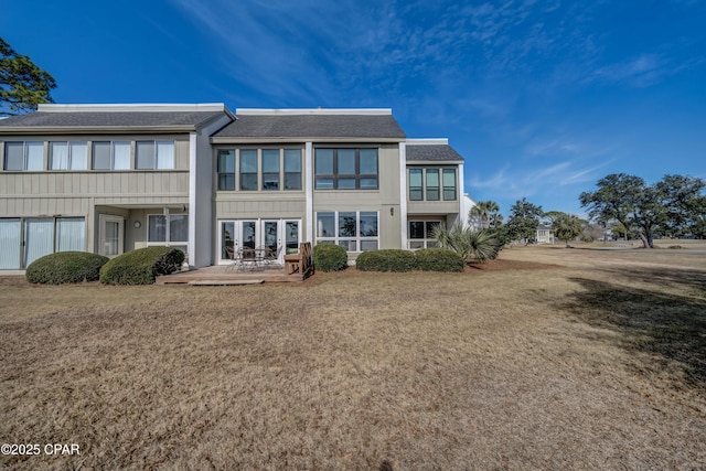 rear view of house featuring a yard and a patio area