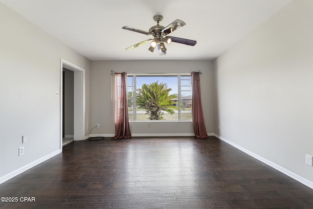 empty room with ceiling fan and dark hardwood / wood-style floors