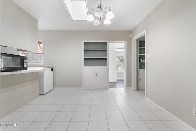 washroom featuring a notable chandelier and light tile patterned floors