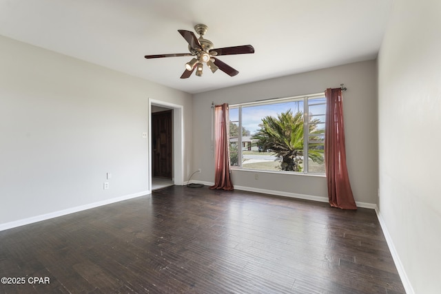 unfurnished room featuring dark wood-type flooring and ceiling fan