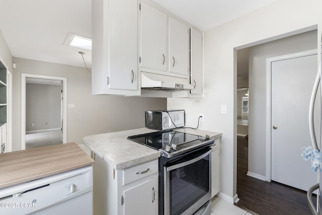 kitchen featuring appliances with stainless steel finishes, white cabinets, and dark hardwood / wood-style flooring