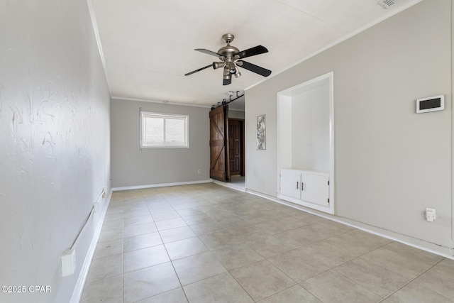 tiled empty room with crown molding, a barn door, and ceiling fan