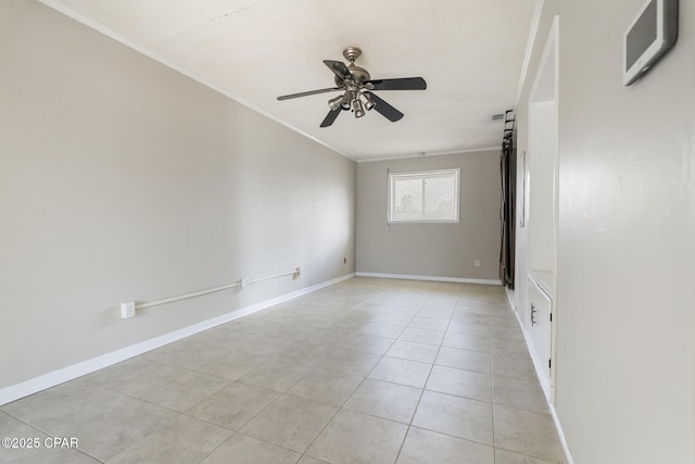 tiled empty room featuring crown molding and ceiling fan