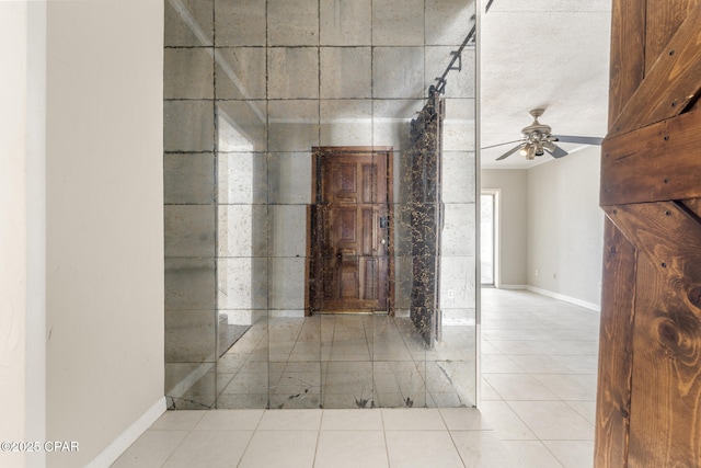 interior space featuring tile patterned floors and ceiling fan