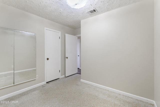 unfurnished bedroom with a closet and a textured ceiling