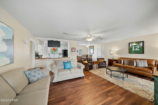 living room featuring hardwood / wood-style floors, a textured ceiling, and ceiling fan