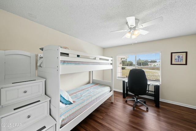 bedroom with ceiling fan, dark wood-type flooring, and a textured ceiling