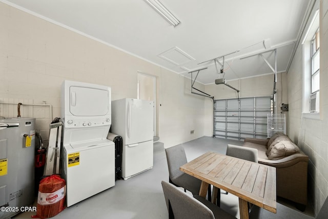 garage featuring white refrigerator, a garage door opener, electric water heater, and stacked washing maching and dryer