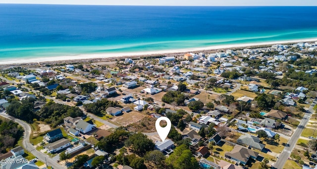 aerial view with a water view and a beach view