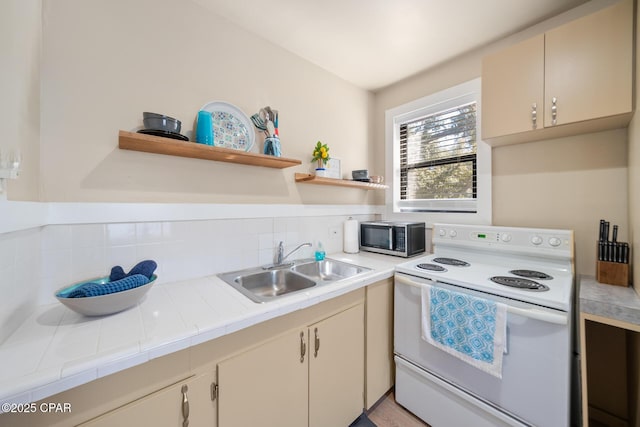 kitchen featuring sink, electric range, decorative backsplash, tile countertops, and cream cabinetry